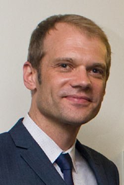 Business professional analyzing currency risks for UK SMEs - Global Banking & Finance Review