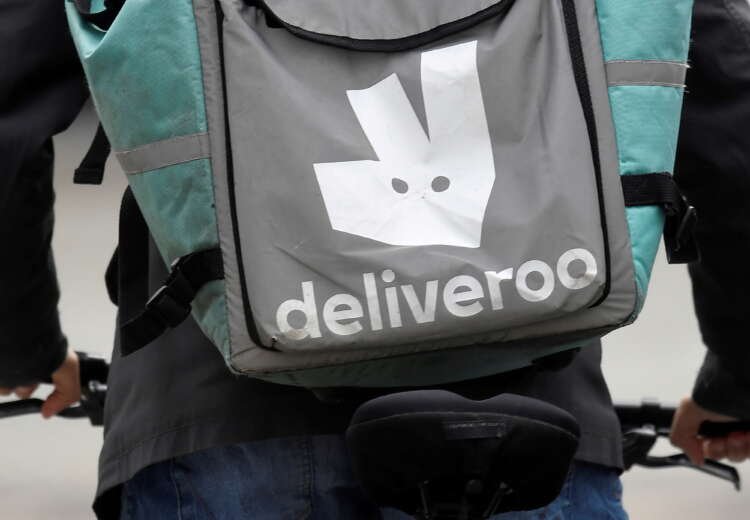 Deliveroo delivery rider cycling in London, reflecting new tech job growth - Global Banking & Finance Review
