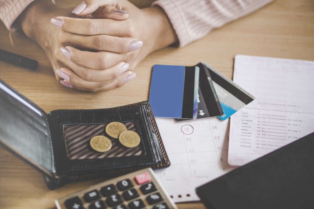 Concerned woman reviewing credit card payment due date amidst payment fraud issues - Global Banking & Finance Review