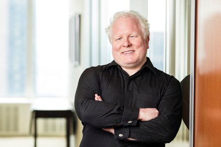 Professional headshot of Chris Boos, CEO of arago, discussing digital labor in business - Global Banking & Finance Review