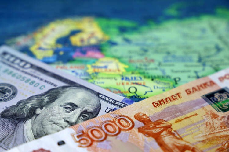 Map of Russia and Ukraine with US dollars and Russian rubles illustrating cross border payments - Global Banking & Finance Review