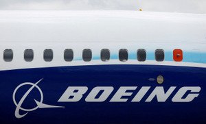 Boeing logo with financial charts highlighting $4 billion quarterly loss - Global Banking & Finance Review