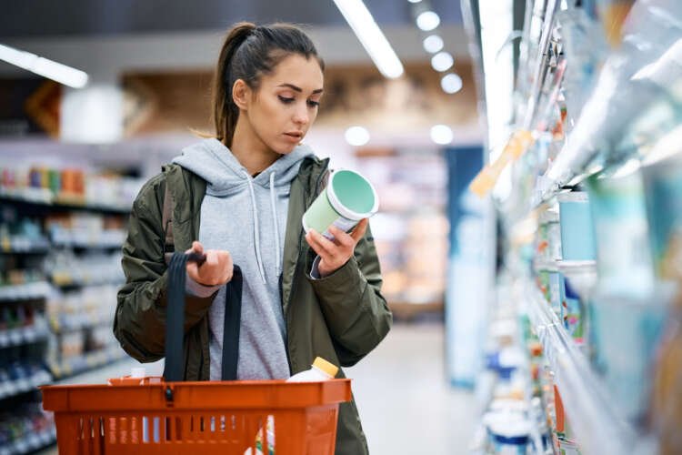 Young woman using a digital wallet for contactless payment in a store - Global Banking & Finance Review