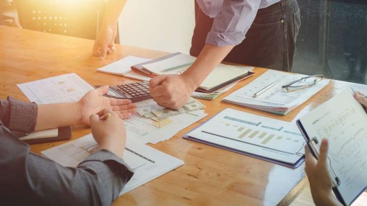 Business owners reviewing equipment financing options for growth - Global Banking & Finance Review