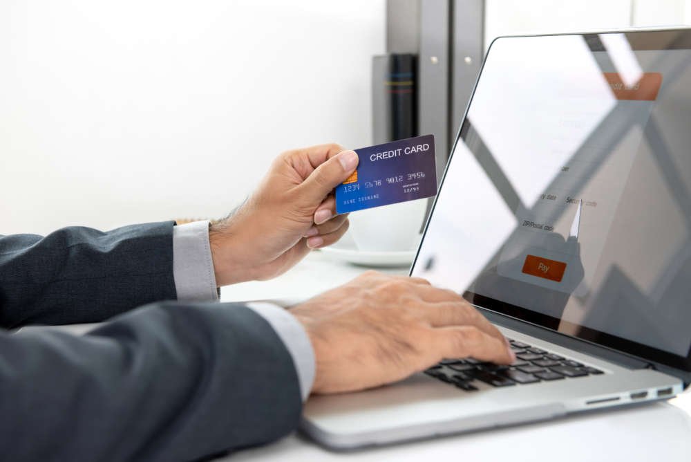 Businessman making secure online payment with credit card and laptop - Global Banking & Finance Review