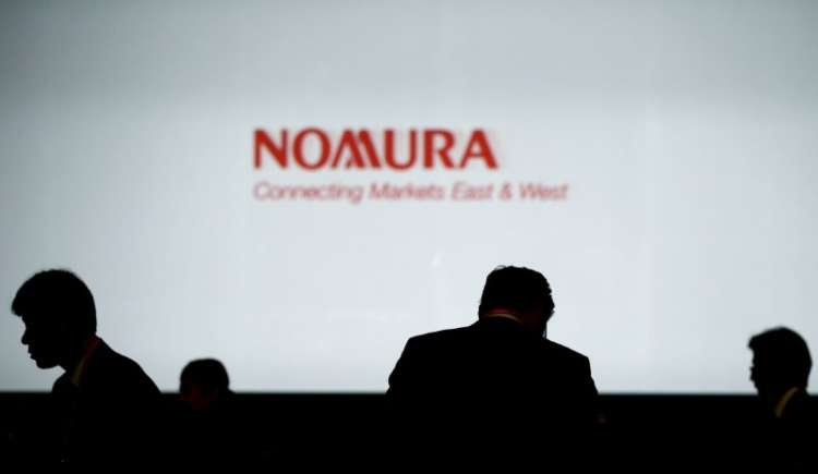 Investors in front of Nomura Holdings logo amid Archegos loss investigation - Global Banking & Finance Review