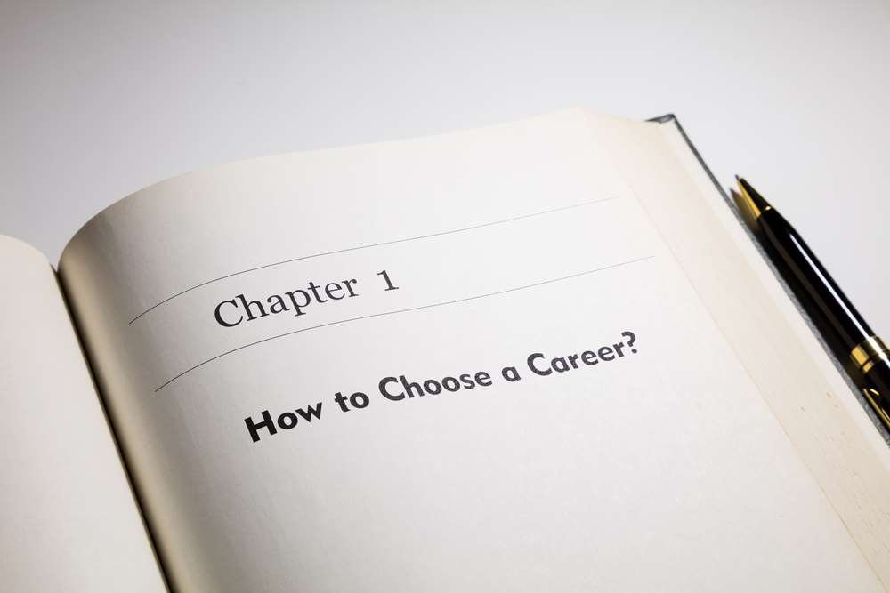 A young professional contemplating career choices with a notebook - Global Banking & Finance Review