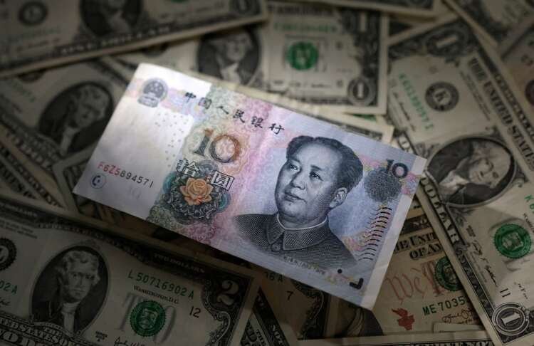 U.S. dollar and Chinese yuan banknotes illustrating currency fluctuations - Global Banking & Finance Review