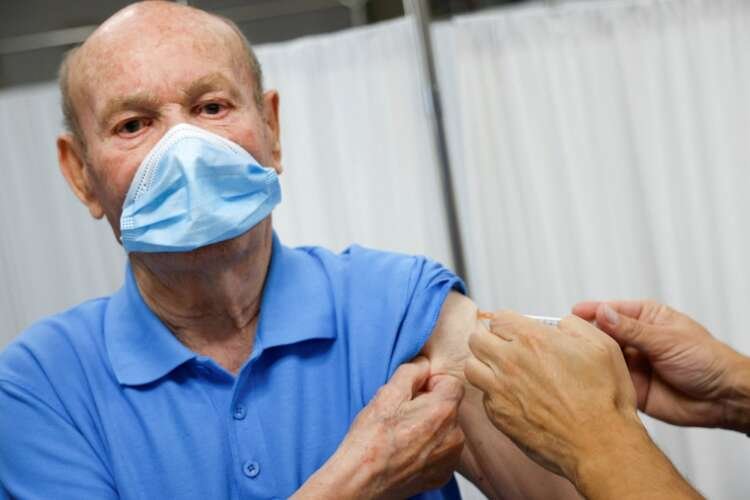 Elderly individuals receiving COVID-19 vaccine boosters amid winter flu season - Global Banking & Finance Review