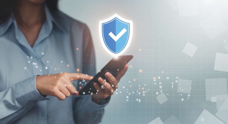 Woman entering a one-time password on a mobile device for secure banking verification - Global Banking & Finance Review