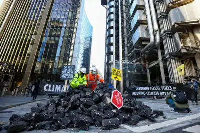 Image for Activists dump fake coal outside Lloyd’s of London in fossil fuel protest