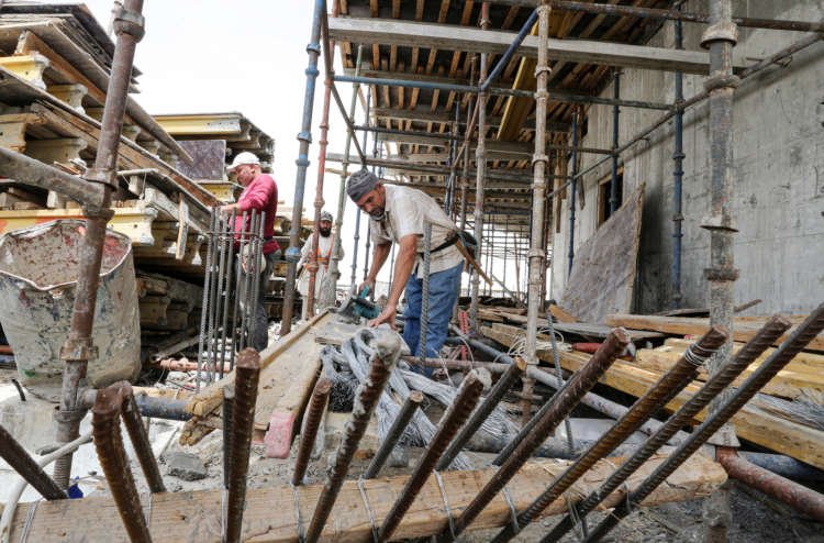 Foreign workers work at a construction site, following the outbreak of the coronavirus disease (COVID-19), in Riyadh