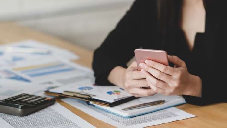 Person reviewing banking options for current accounts with bad credit - Global Banking & Finance Review