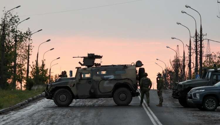 Pro-Russian soldiers stand guard at the Azovstal steel factory in Mariupol - Global Banking & Finance Review