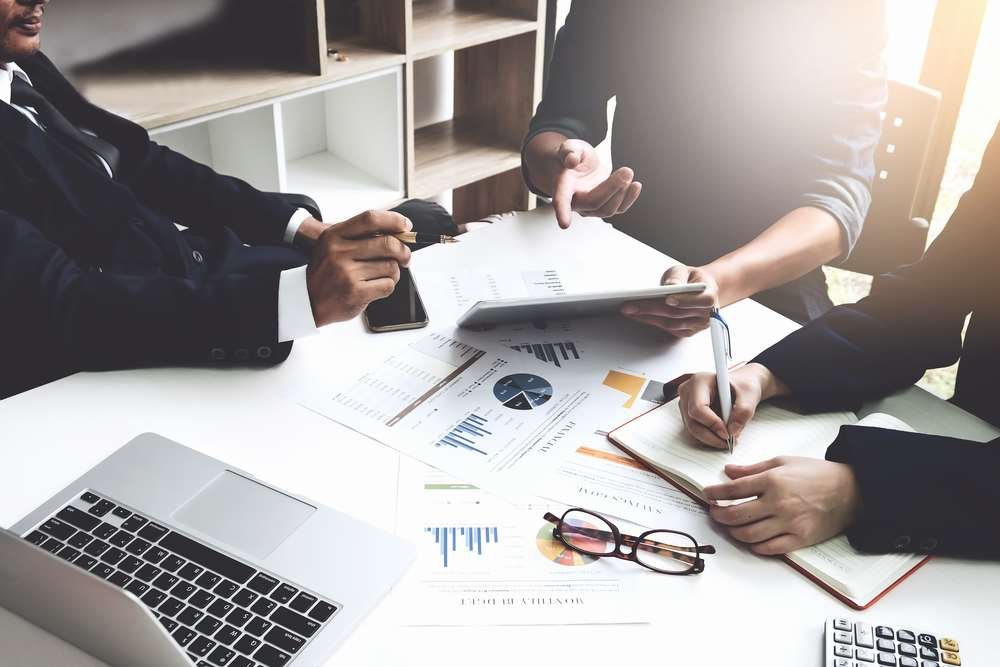 Team discussing strategies to improve employee retention in the workplace - Global Banking & Finance Review