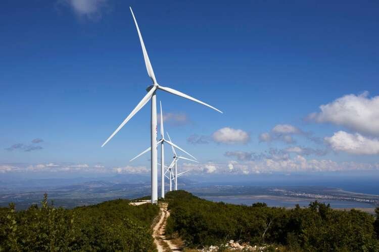 Wind turbines at Mozura wind farm symbolize green energy bonds - Global Banking & Finance Review