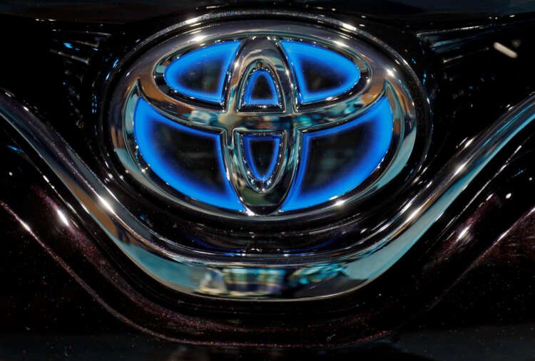 Toyota logo displayed on a vehicle, reflecting the automaker's climate strategy - Global Banking & Finance Review