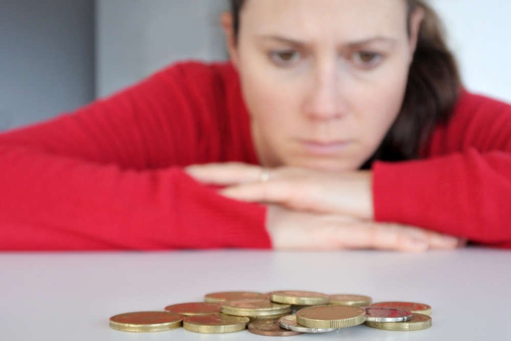 Young woman looking stressed about financial decisions - Global Banking & Finance Review