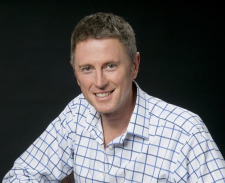 Professional portrait of Andy Moore discussing technology's impact on business - Global Banking & Finance Review