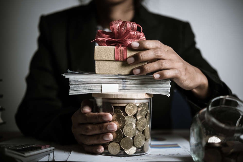 Businessman donating money to charity in a post-COVID-19 fundraising context - Global Banking & Finance Review