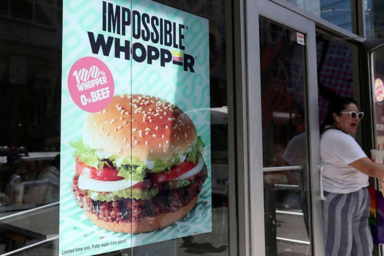 FILE PHOTO: A sign advertising the soy based Impossible Whopper is seen outside a Burger King in New York
