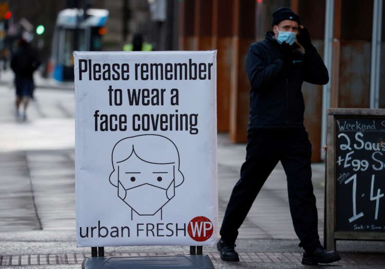 Sign encouraging people to wear face coverings amid the COVID-19 outbreak in Belfast