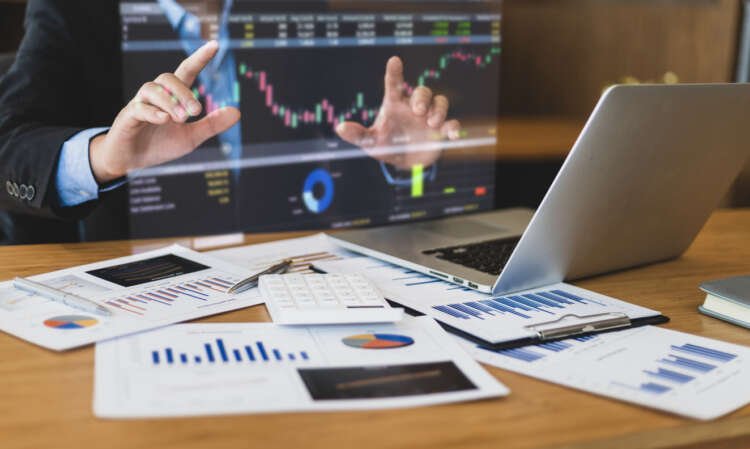 Businessman analyzing financial data with technology tools for portfolio management - Global Banking & Finance Review