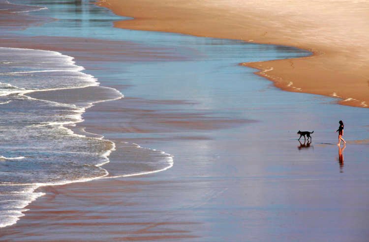 Tourists at a popular beach destination, reflecting influencer culture - Global Banking & Finance Review