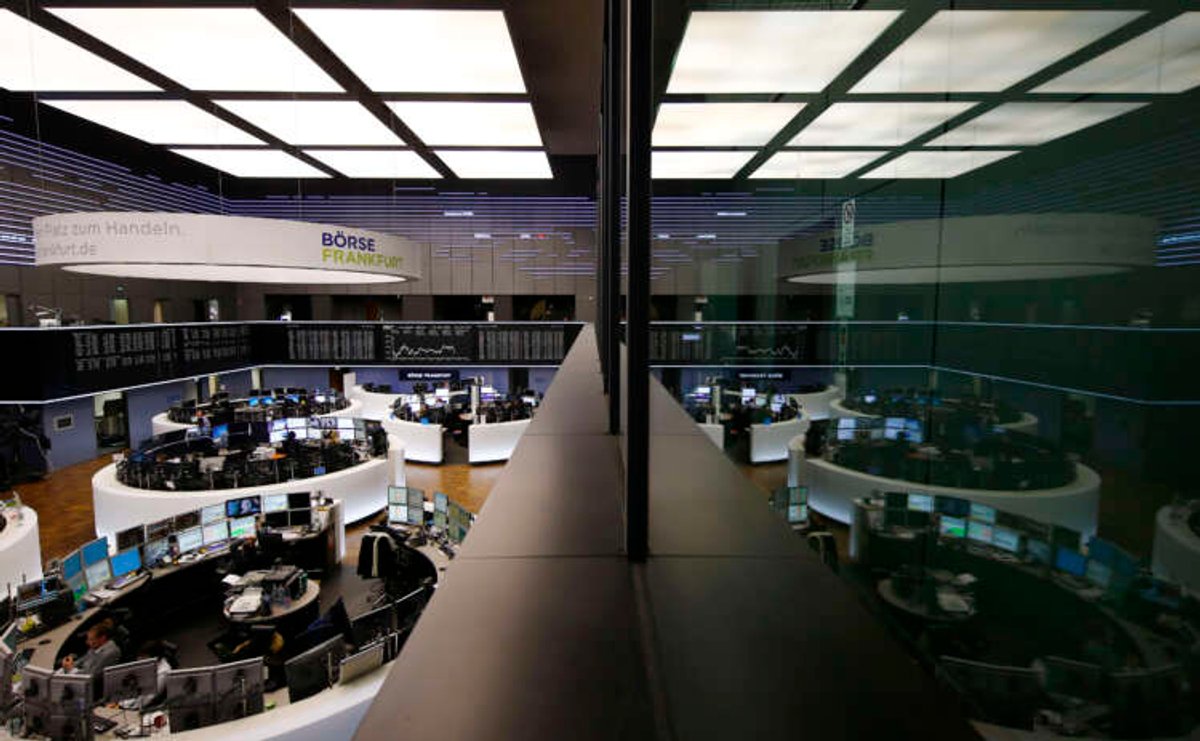 The trading room of Frankfurt’s stock exchange is reflected in the window of the visitor’s gallery during afternoon trading session in Frankfurt