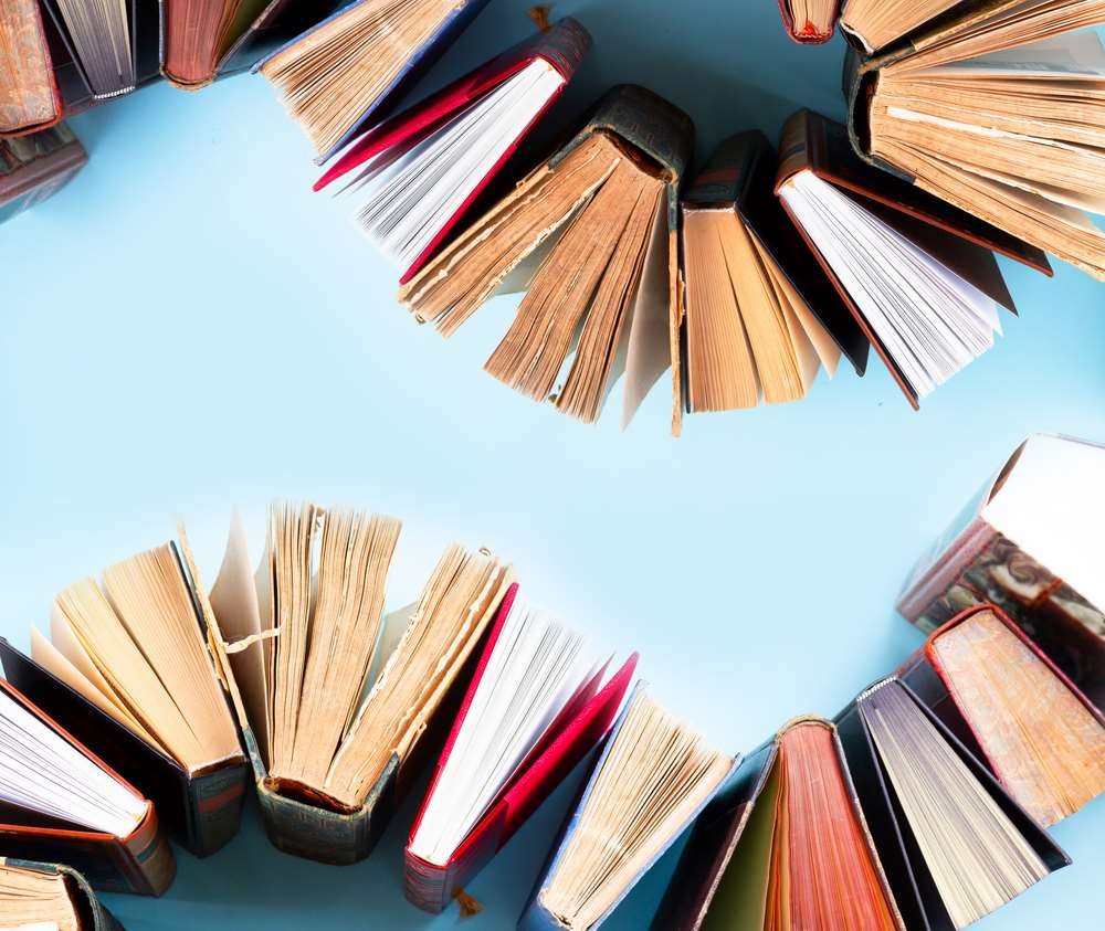 Group of friends discussing books in a cozy setting - How to Start a Book Club - Global Banking & Finance Review