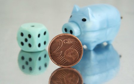 Piggy bank with coins symbolizing financial compliance challenges - Global Banking & Finance Review