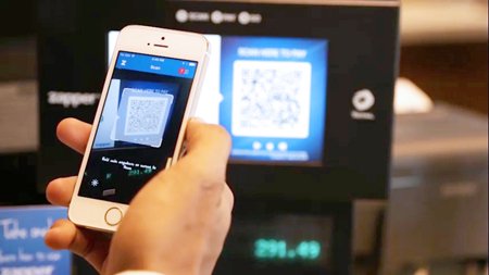 A customer scanning a QR code for mobile payment at a retail store - Global Banking & Finance Review
