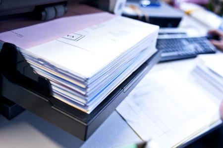 A stack of paper documents symbolizing data management in banking - Global Banking & Finance Review