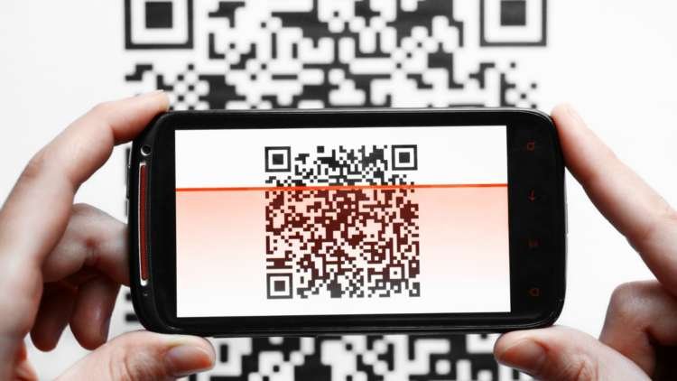 Close-up of a smartphone scanning a QR code for smart ticketing in finance - Global Banking & Finance Review