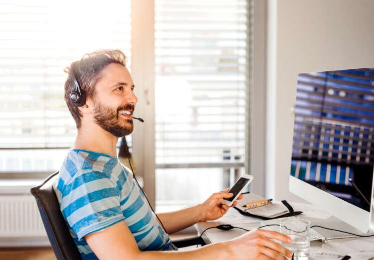 Man sitting at desk working from home on computer