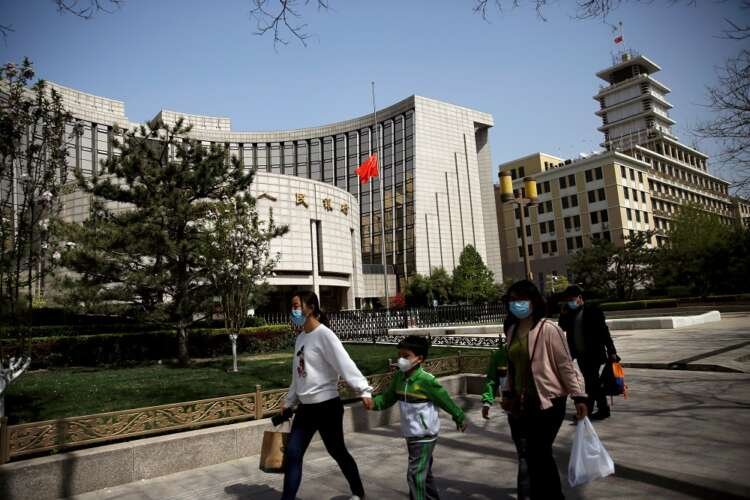 People walking near the PBOC headquarters, symbolizing China-Russia financial discussions - Global Banking & Finance Review
