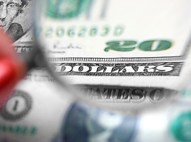 inspecting a twenty dollar