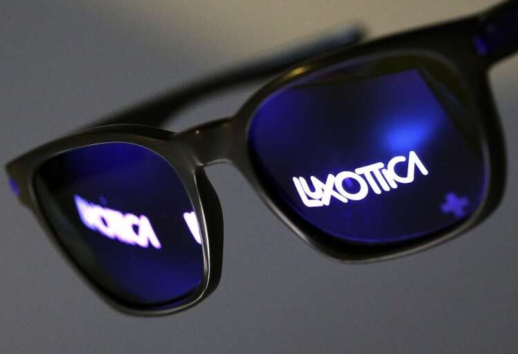Luxottica logo reflected in sunglasses, symbolizing Del Vecchio's impact on eyewear - Global Banking & Finance Review