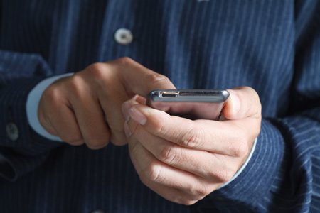 Touch screen mobile phone showcasing mobile banking app features - Global Banking & Finance Review