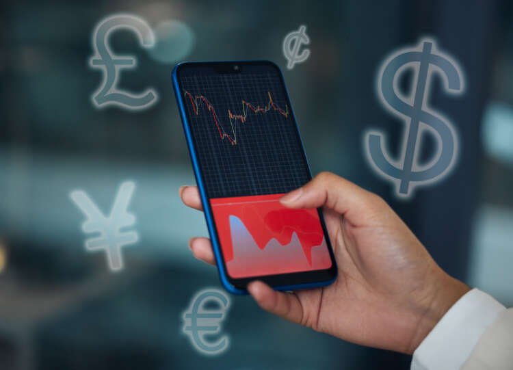 Businesswoman analyzing real-time FX market data on her cellphone - Global Banking & Finance Review