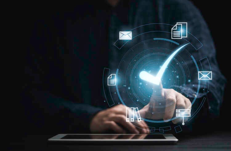 Businessman using a tablet to demonstrate automation in digital infrastructure management - Global Banking & Finance Review