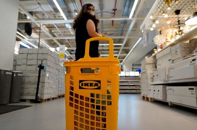 A woman shopping in IKEA's city store, showcasing e-commerce adaptations - Global Banking & Finance Review