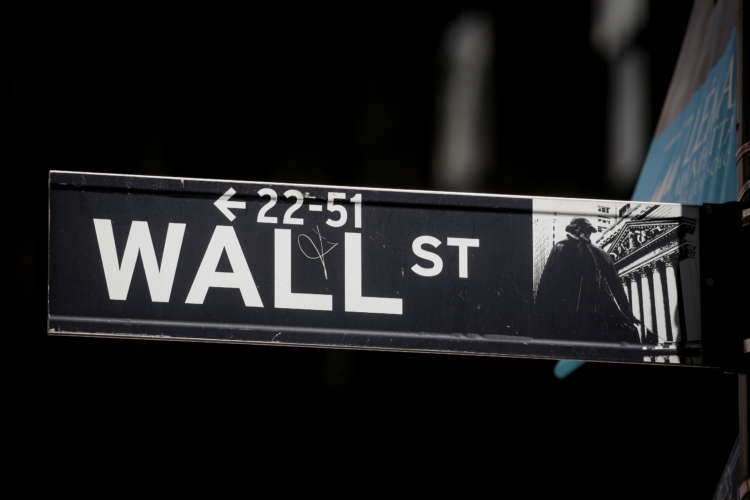 Wall St. sign near the NYSE, symbolizing market trends for investors - Global Banking & Finance Review