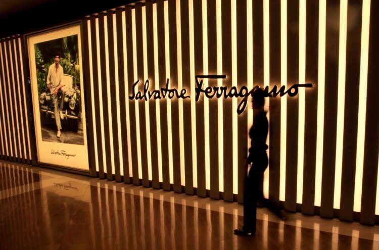 FILE PHOTO: A woman walks past a Salvatore Ferragamo shop in Singapore