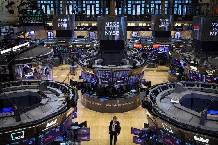 Trader on the NYSE floor during Wall Street rally amid rising Treasury yields - Global Banking & Finance Review