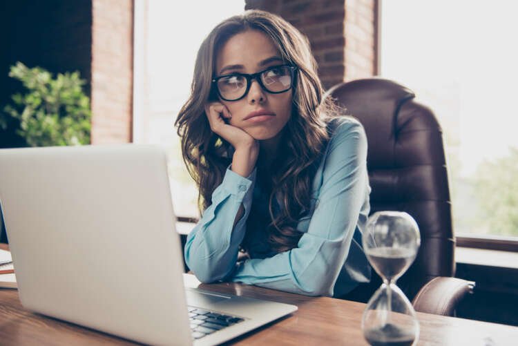 Frustrated businesswoman contemplating job change, representing signs to find a new job - Global Banking & Finance Review
