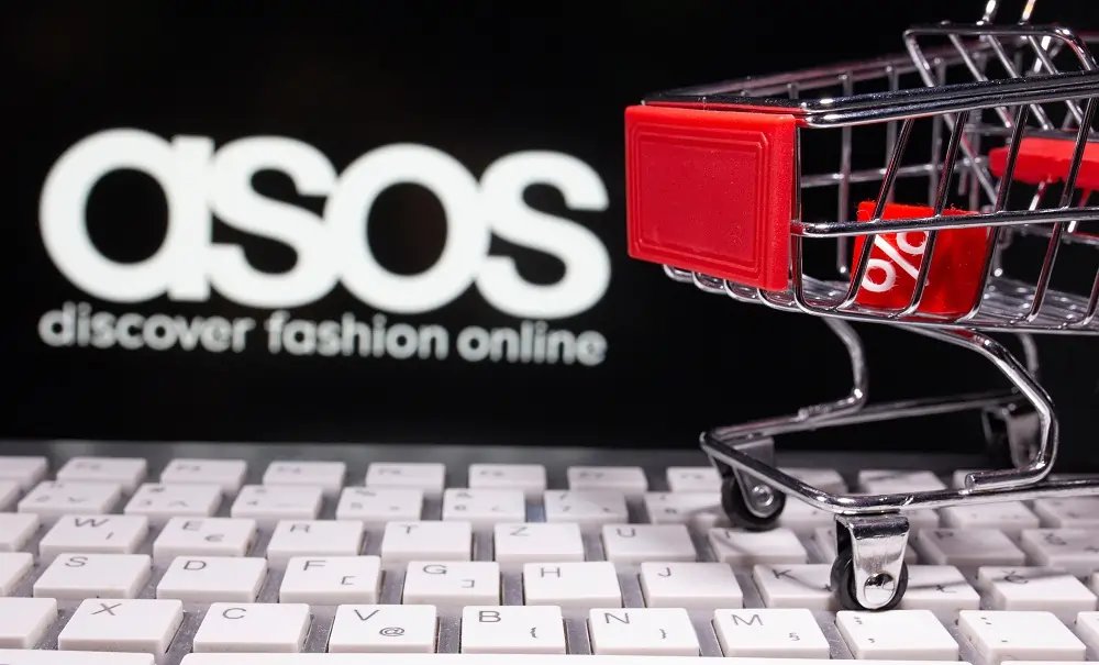 ASOS logo with a backdrop of fashion items highlighting the brand's market challenges - Global Banking & Finance Review