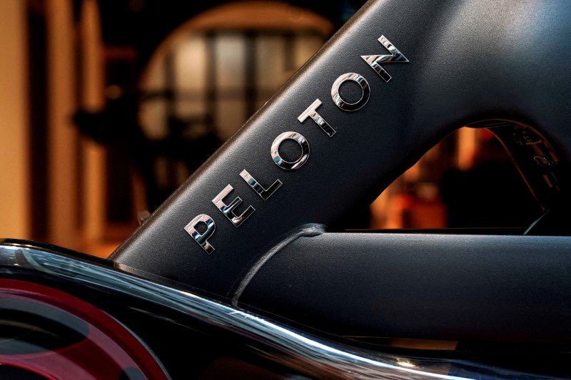 Peloton logo with fitness equipment, representing shareholder lawsuit dismissal - Global Banking & Finance Review