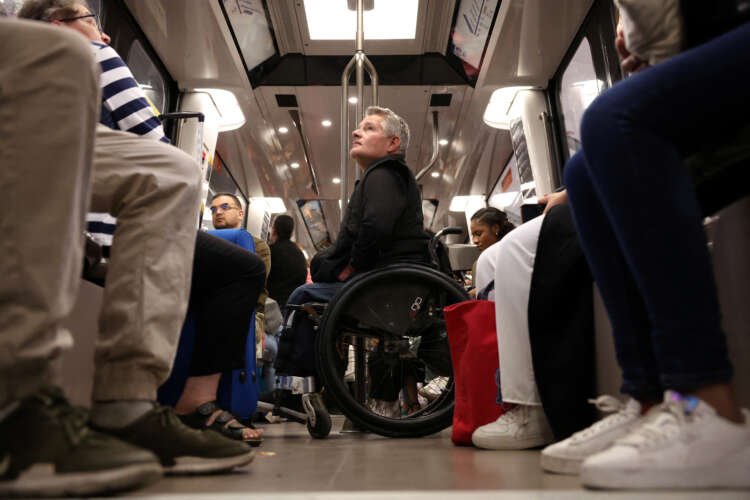 Wheelchair user navigating Paris streets, highlighting transport accessibility issues for Olympics - Global Banking & Finance Review