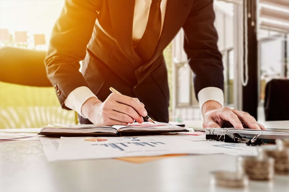 Young business man analyzing financial data for ethical accountancy practices - Global Banking & Finance Review